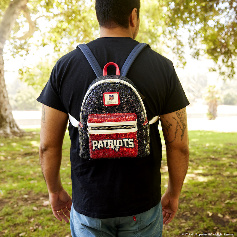 Man facing away from camera wearing the NFL New England Patriots Sequin Mini Backpack 